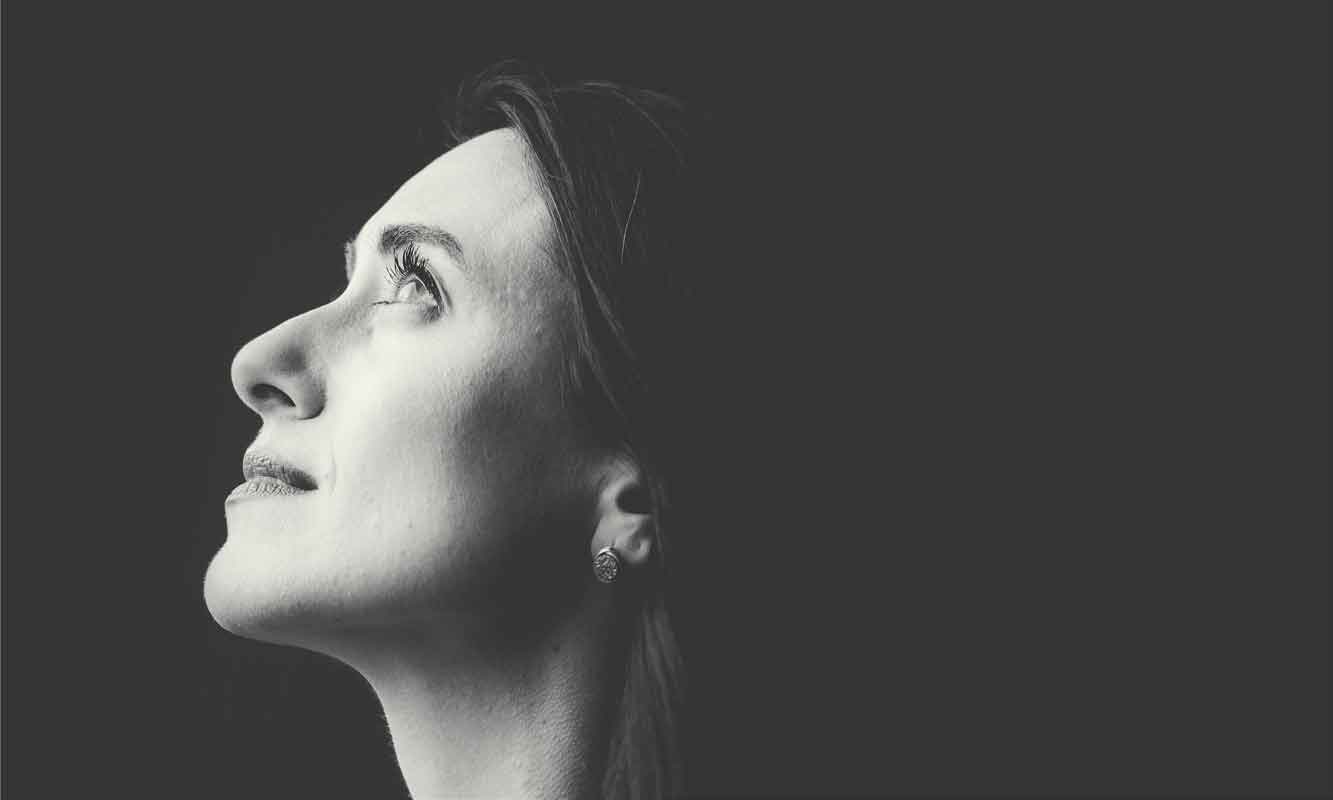 Woman looking up, representing hope during anxiety treatment