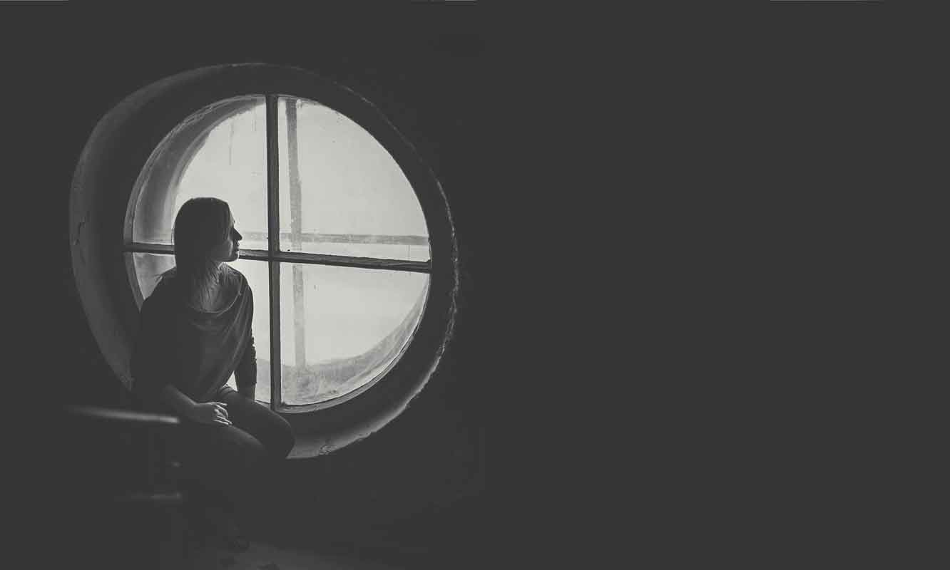 Woman sitting peacefully by a window